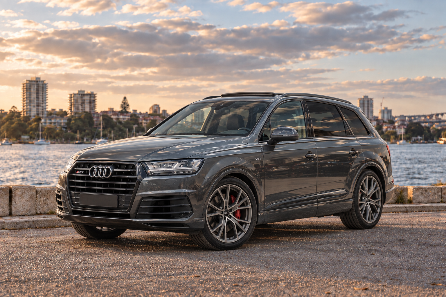 Audi SQ7 on a Sydney waterfront backdrop at sunset